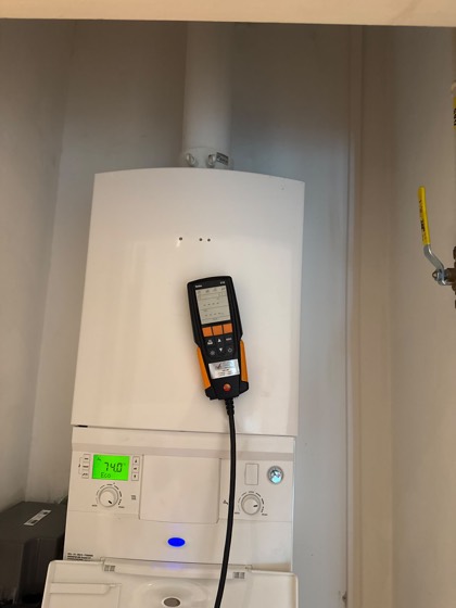 A boiler service with the flue gas analyser connected